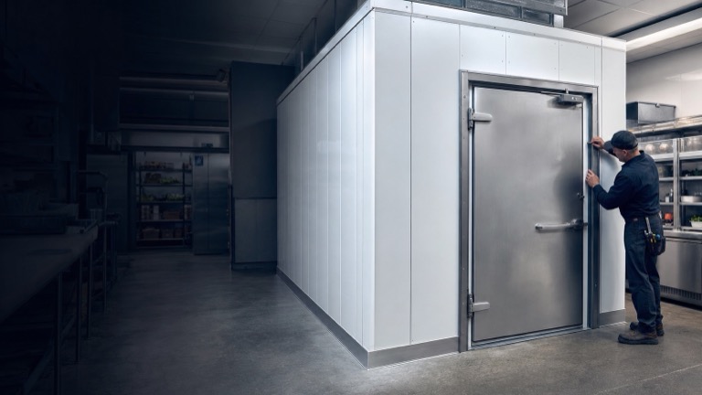 New commercial walk-in cooler enclosure in a market back room